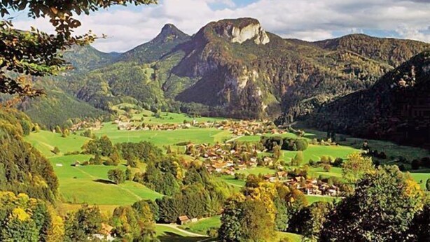 Paisagem montanhosa com uma aldeia aninhada no vale.
