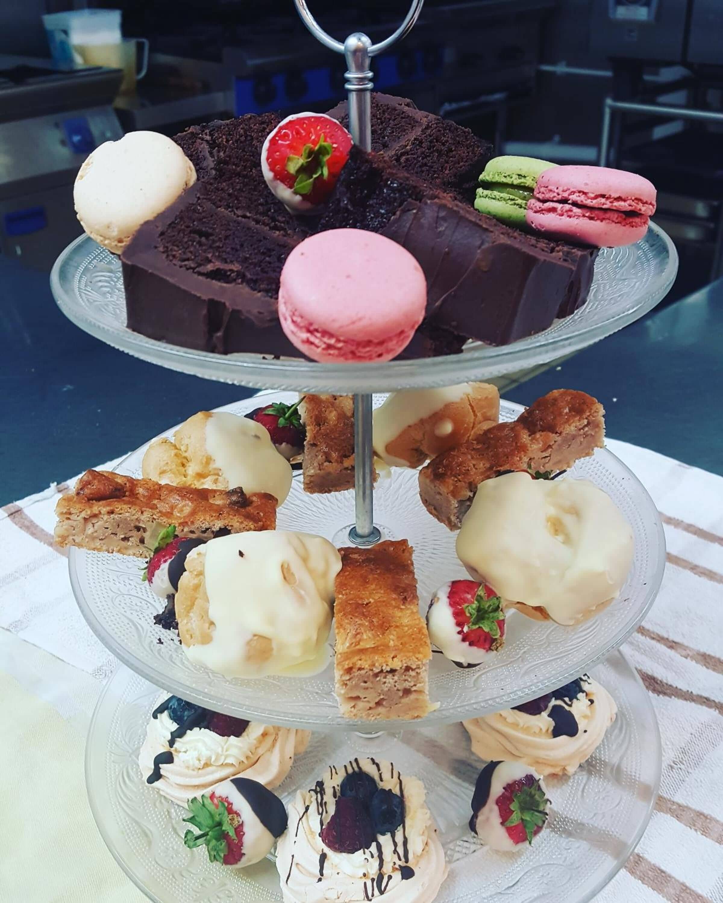 A multi-tiered dessert display with various pastries and desserts.