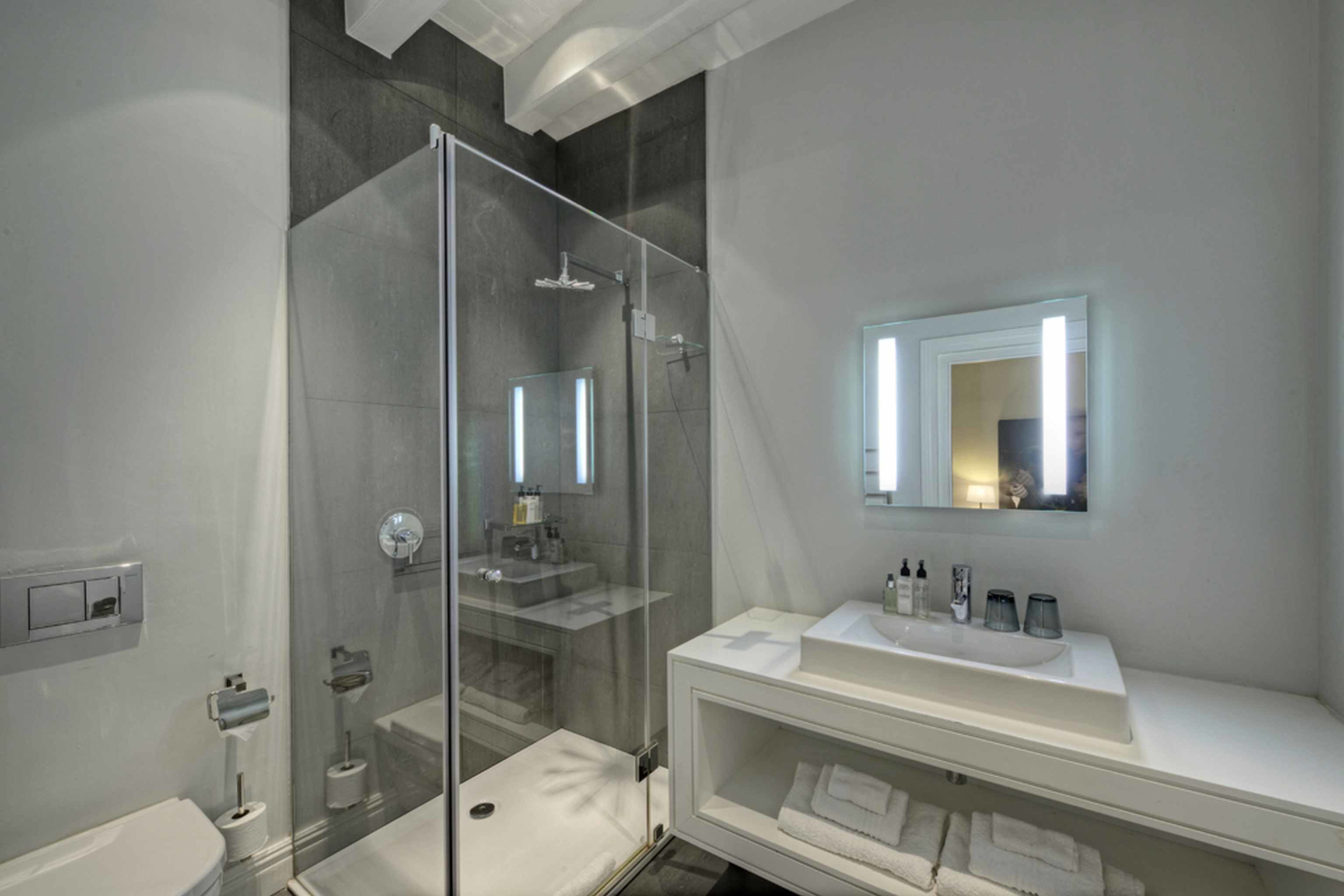 luxury room, pool view | bathroom | rainfall showerhead, hair dryer, bathrobes, slippers