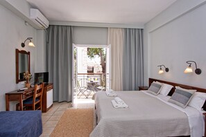 A hotel room with a bed, desk, chair, TV, and a balcony with a table and chairs. - Hotel Katia (South Pelion)