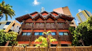 A multi-story building with a distinctive thatched roof and balconies. - Safari Natal Beach Hotel (Natal)