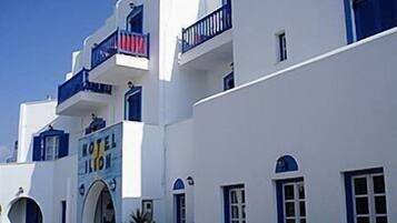 A white building with blue accents, including balconies and windows.