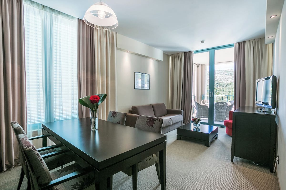 Two bedroom suite | Living area | 32-inch LCD TV with satellite channels, TV