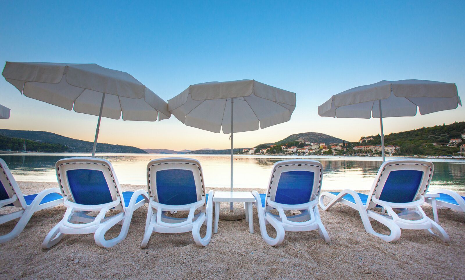 on the beach, white sand, sun-loungers, beach umbrellas