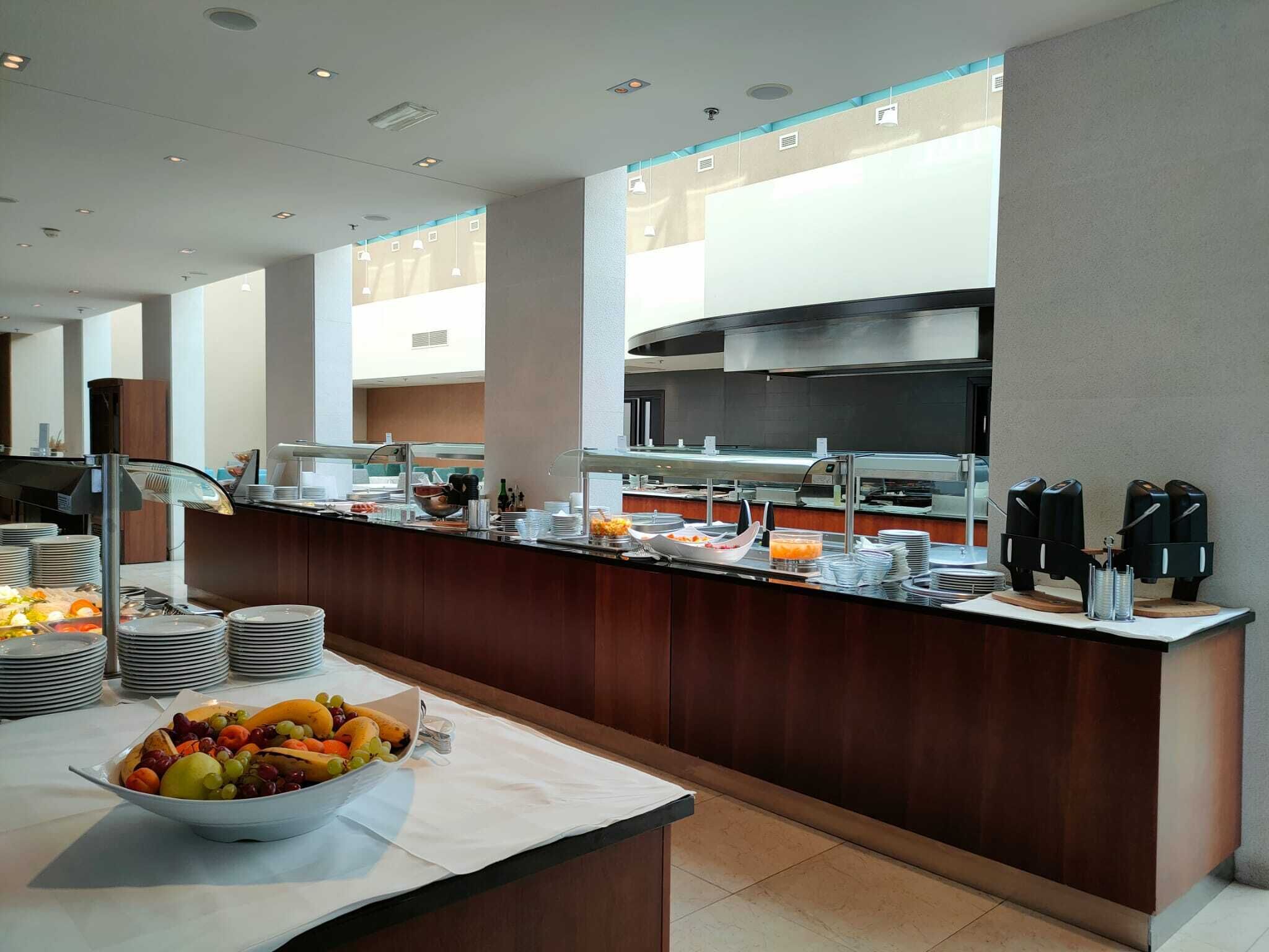 A buffet setup with various food items and a coffee station.
