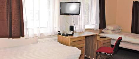 A hotel room with two beds, a desk with a television, and a chair.