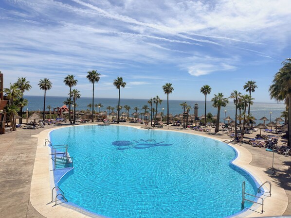 Indoor pool, outdoor pool, pool umbrellas, pool loungers