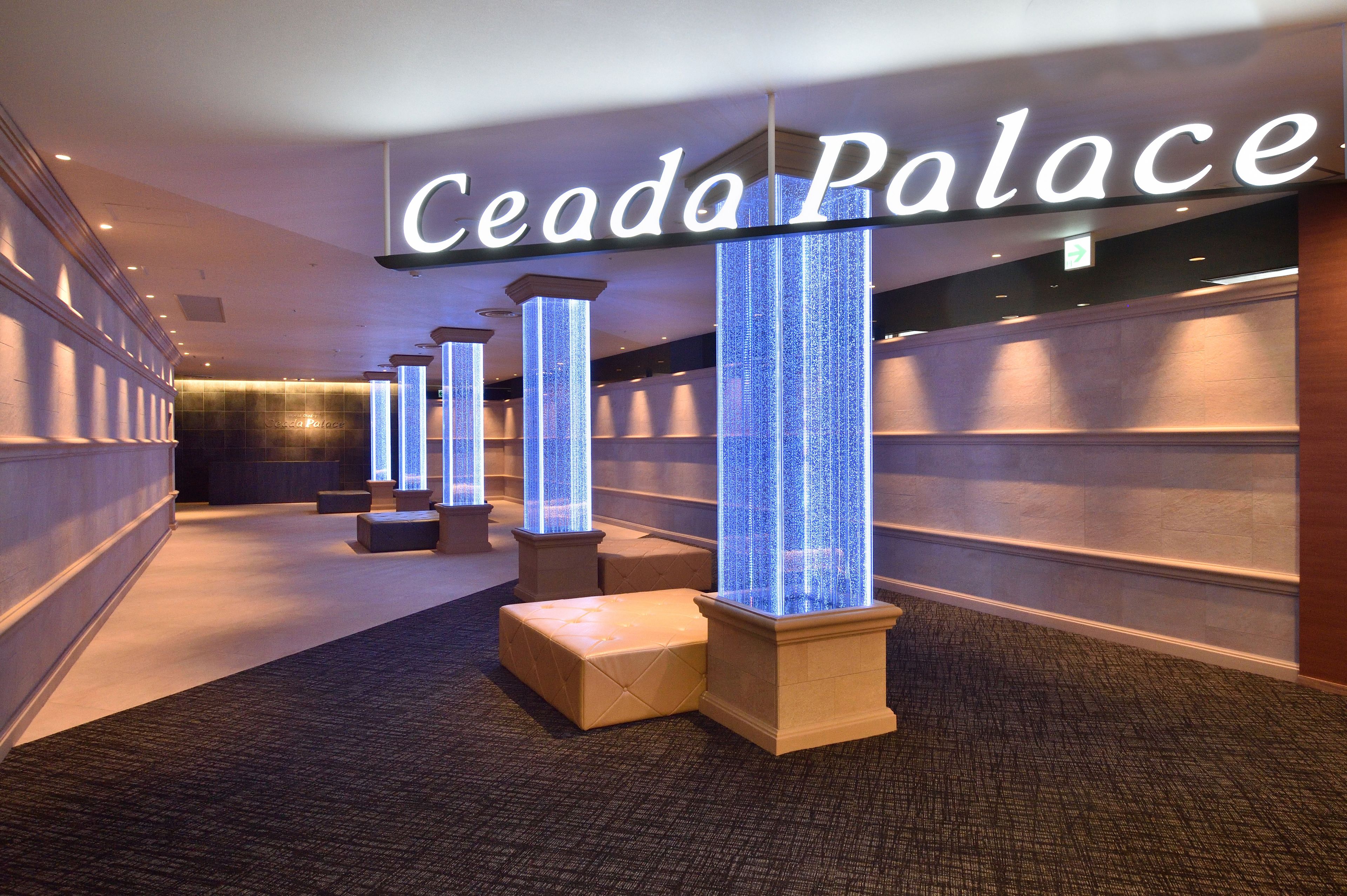 A hallway with illuminated pillars and a sign reading "Ceada Palace".