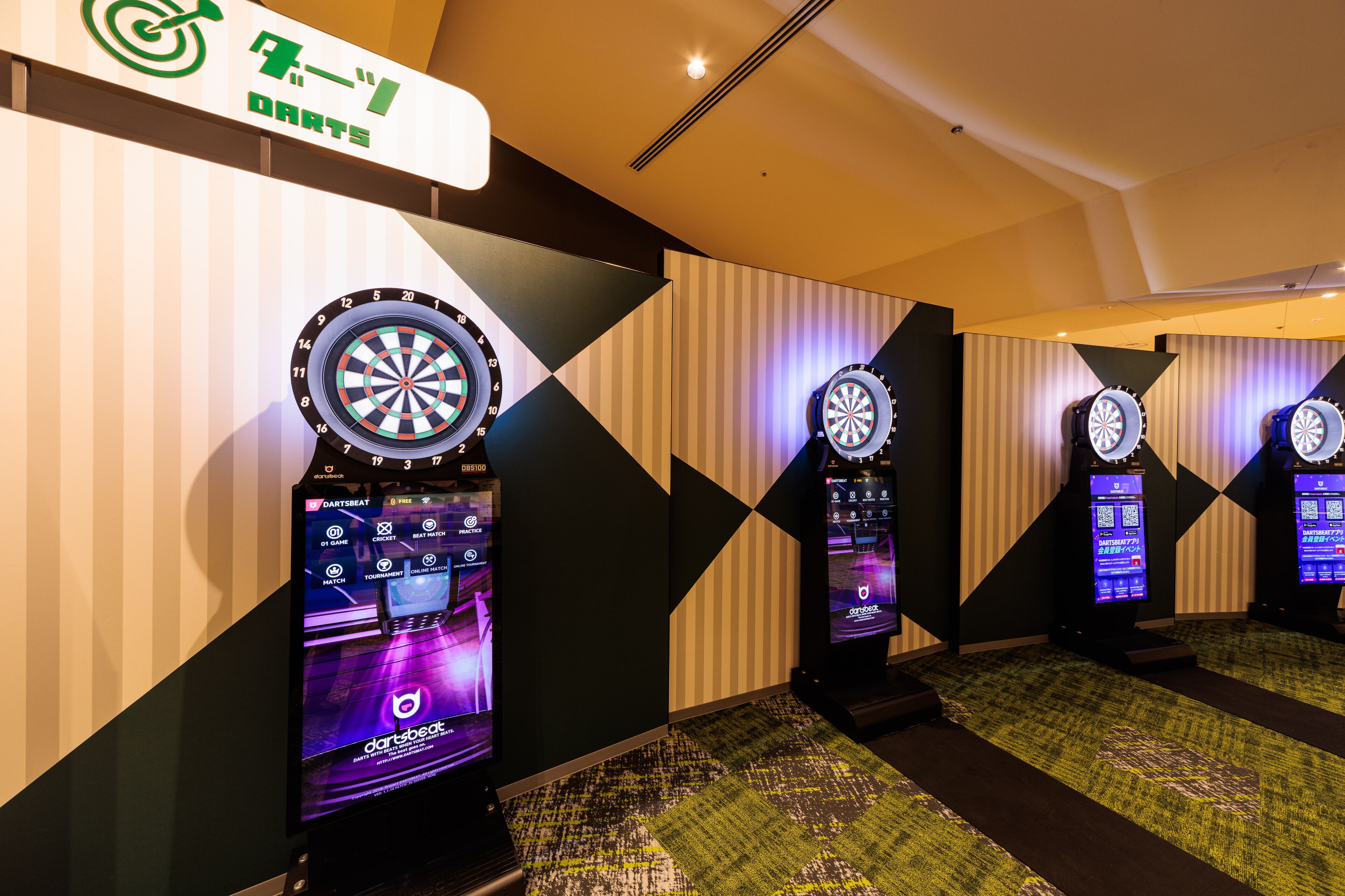 A darts game area with multiple dartboards and electronic scoreboards.