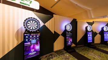 A darts game area with multiple dartboards and electronic scoreboards.