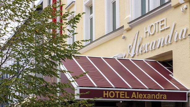 A hotel named HOTEL Alexandra with a maroon awning and a sign above the entrance. - Hotel Alexandra (Plauen)