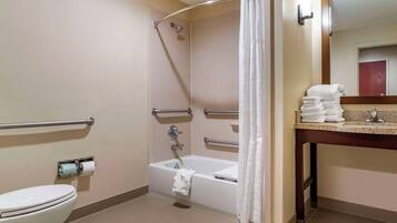 A bathroom with a shower, toilet, and sink.