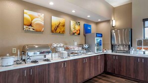 A modern kitchen with a buffet setup, including a rice cooker, toaster, and refrigerated display.