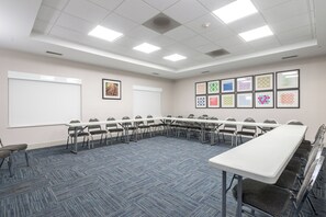 A conference room with a long table, chairs, a whiteboard, and framed pictures on the wall. - Holiday Inn Express & Suites Lagrange I-85 by IHG (LaGrange)
