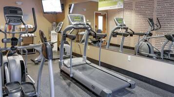 A gym with treadmills, an elliptical, and a stationary bike.
