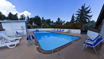 Seasonal outdoor pool, open 9:00 AM to 10:00 PM, pool umbrellas