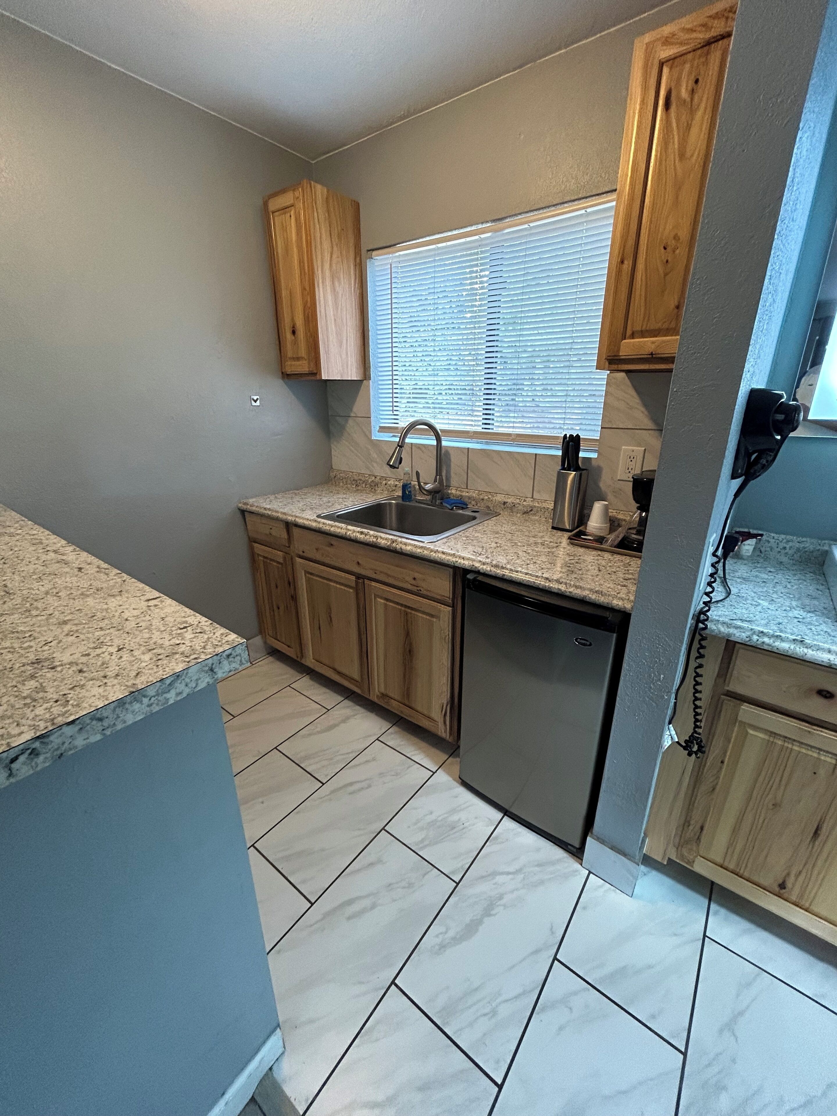 Deluxe Room, 2 Queen Beds, Kitchenette | Living area | TV, printers