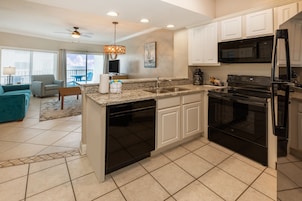 Fridge, microwave, coffee/tea maker, cookware/dishes/utensils