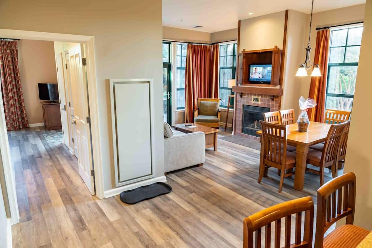 Deluxe Suite, 2 Bedrooms, Fireplace | Living area | 55-inch TV with cable channels, table tennis