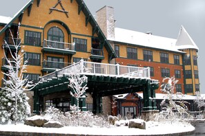 A large, multi-story building with a prominent entrance and a covered walkway. - Mountain Creek (Vernon)