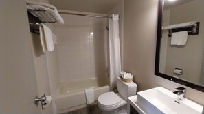 A bathroom with a bathtub, toilet, and sink. - King Edward Hotel  (Banff)