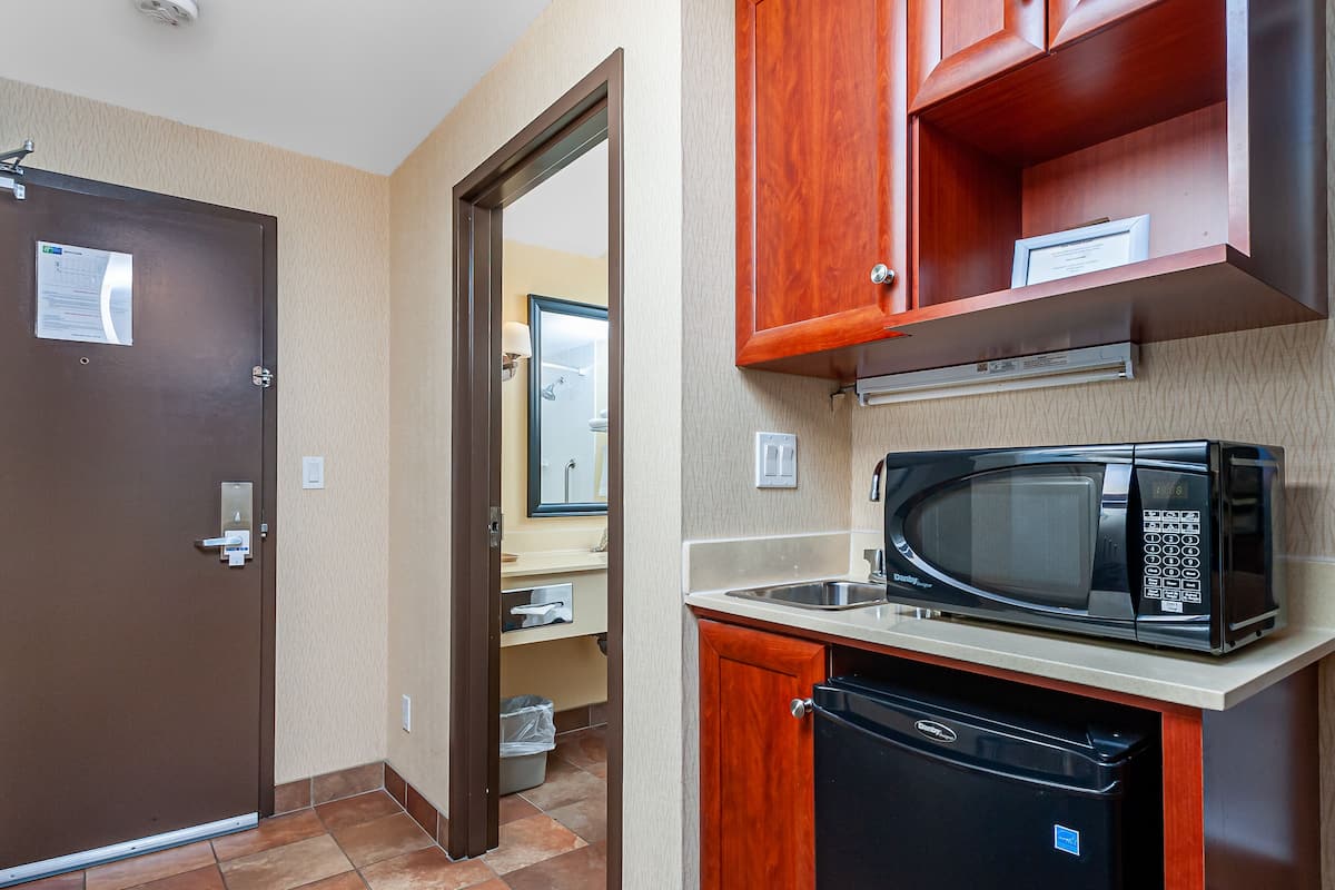 Hypo-allergenic bedding, desk, laptop workspace, blackout drapes