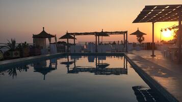 Seasonal outdoor pool, pool umbrellas, pool loungers