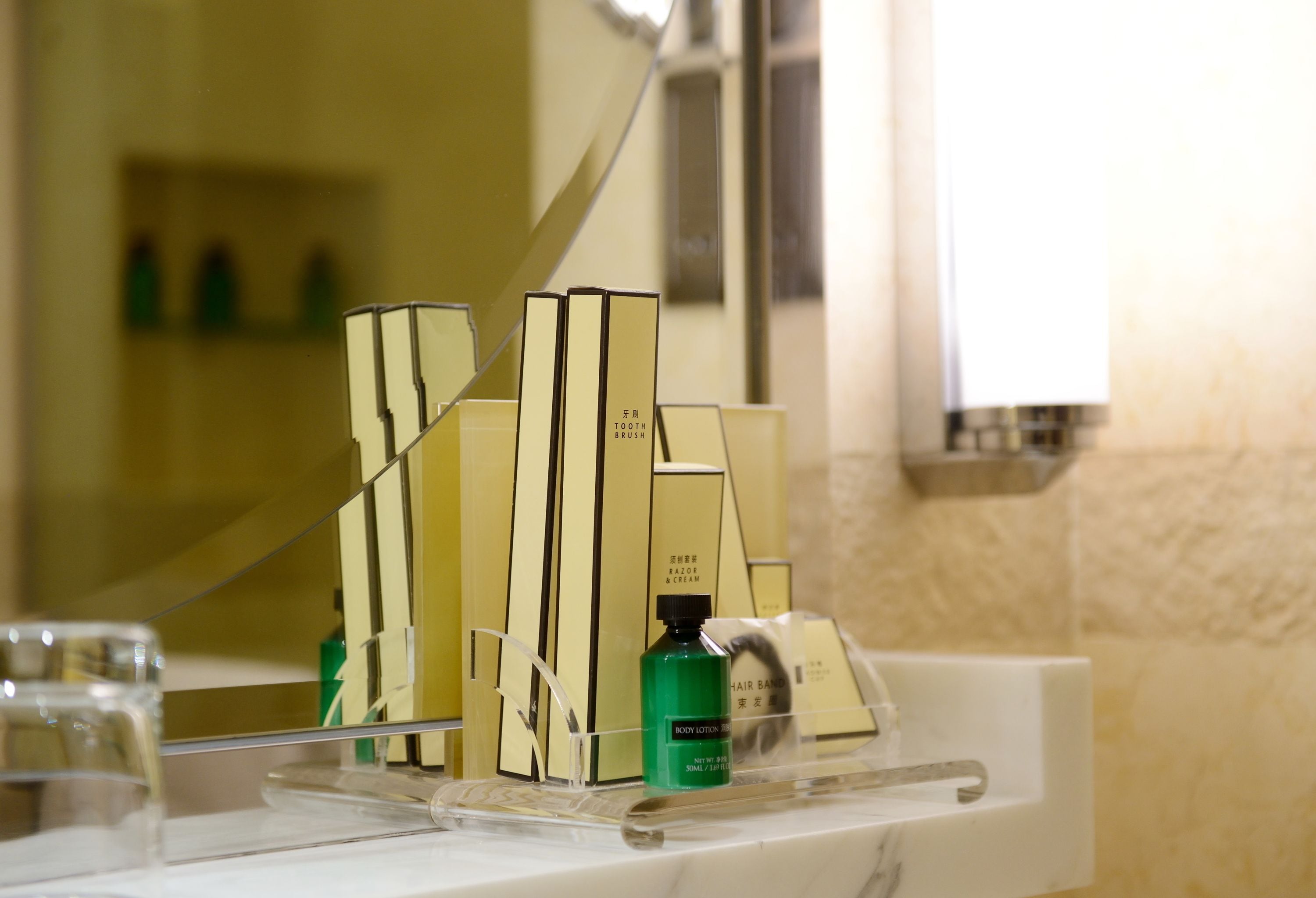 A bathroom vanity with toiletries and a mirror.