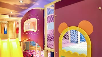 Kids can play and climb in this vibrant play area with a slide, climbing net, and safety netting.