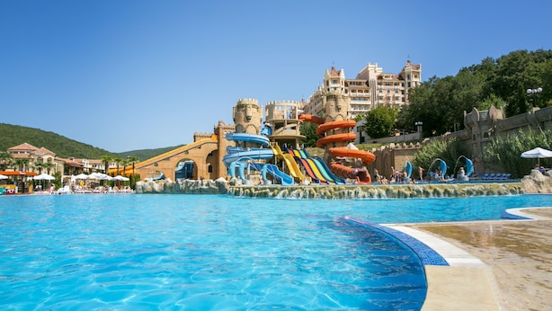 A large swimming pool with a water park area featuring slides and water features. - Royal Park Hotel - All Inclusive (Elenite)
