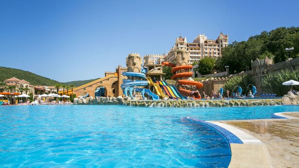 A large swimming pool with a water park area featuring slides and water features. - Villas Elenite - All Inclusive (Elenite)