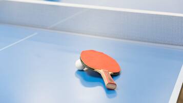 A table tennis table with a blue surface and a net.