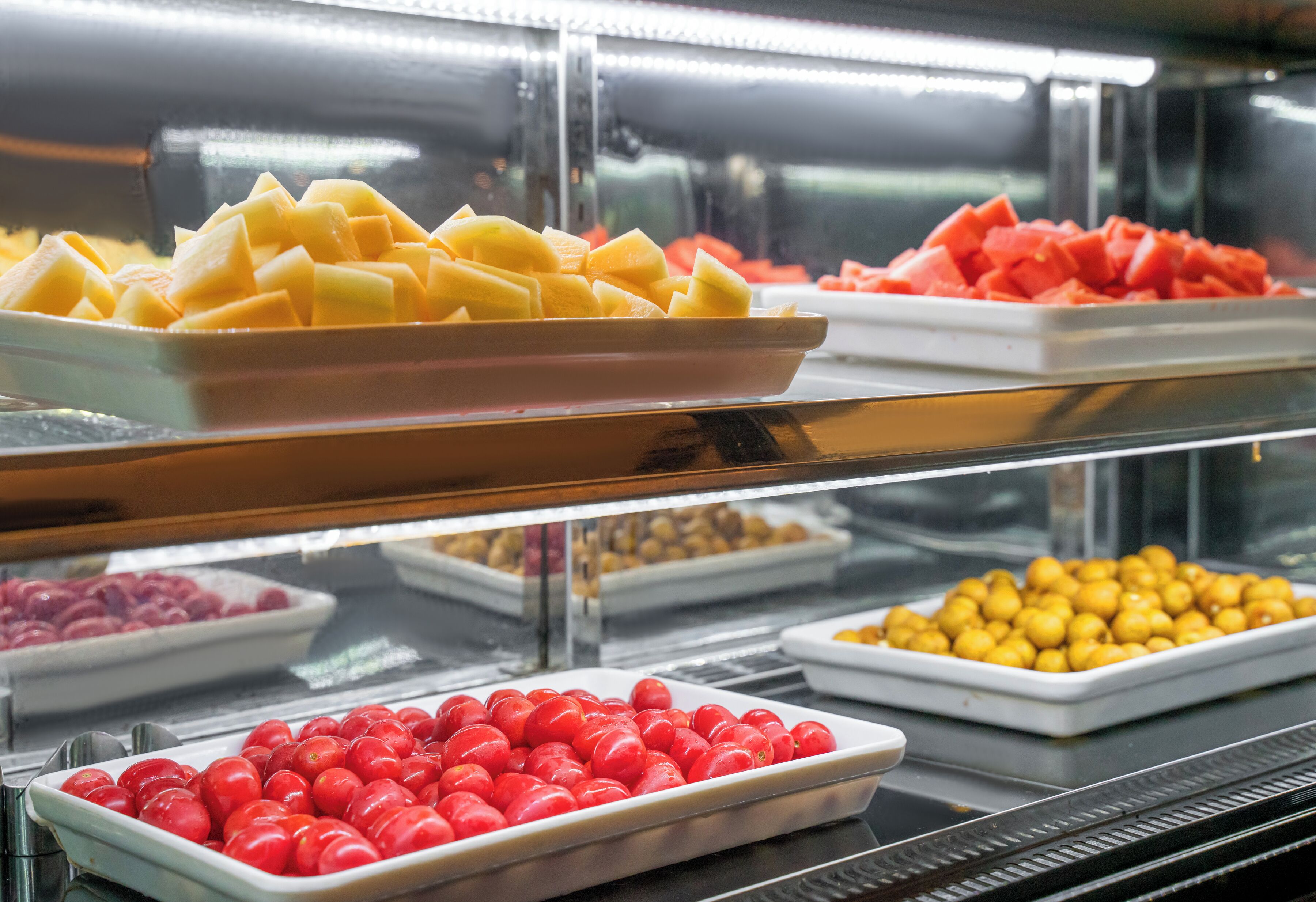 A food display with various fruits and vegetables.