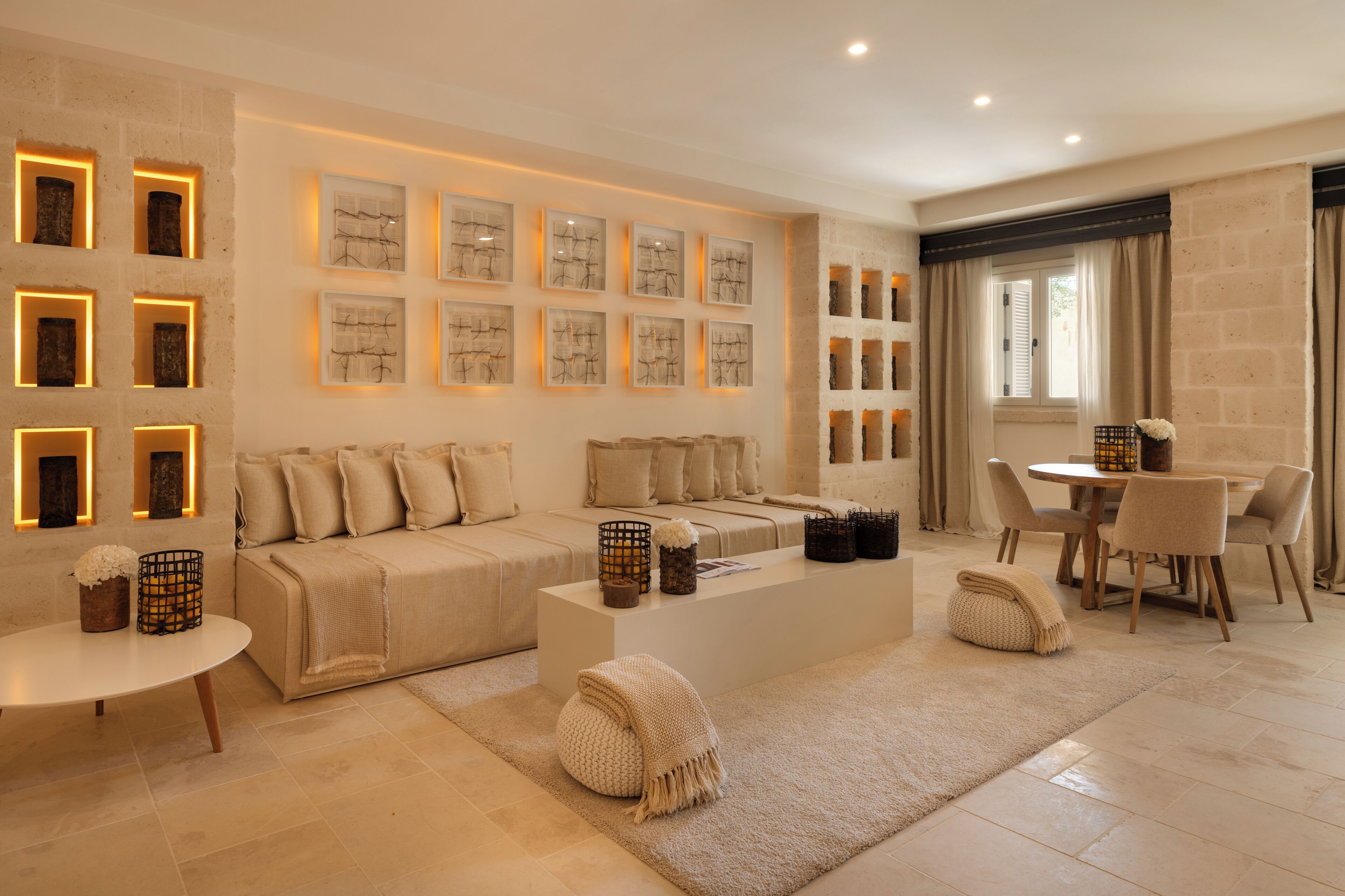 A modern living room with a sofa, coffee table, and wall art.