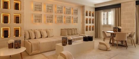 A modern living room with a sofa, coffee table, and wall art.