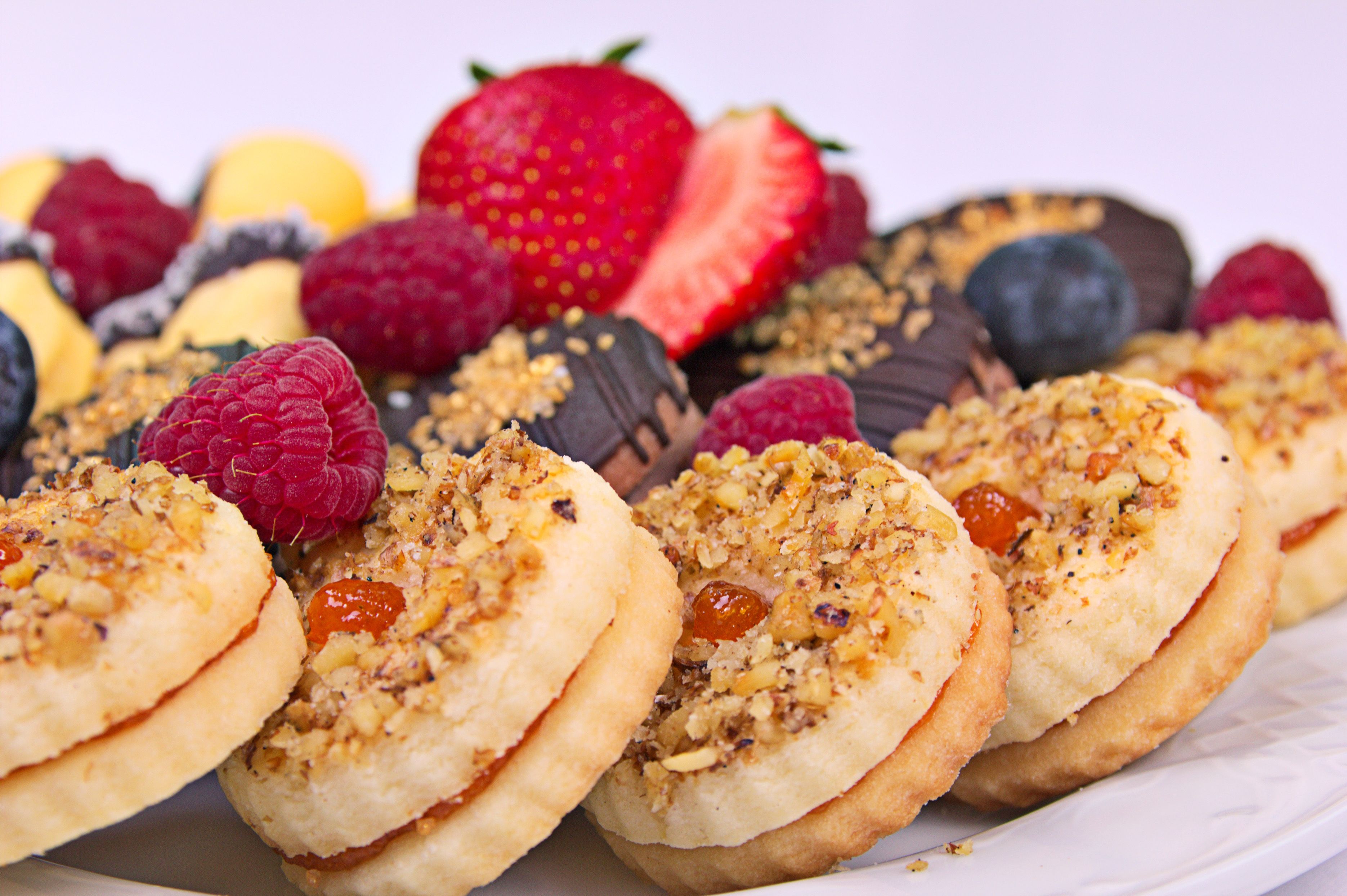 A plate of assorted pastries with fruits and chocolate.