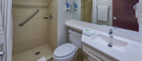 A modern bathroom with a shower, toilet, and sink.
