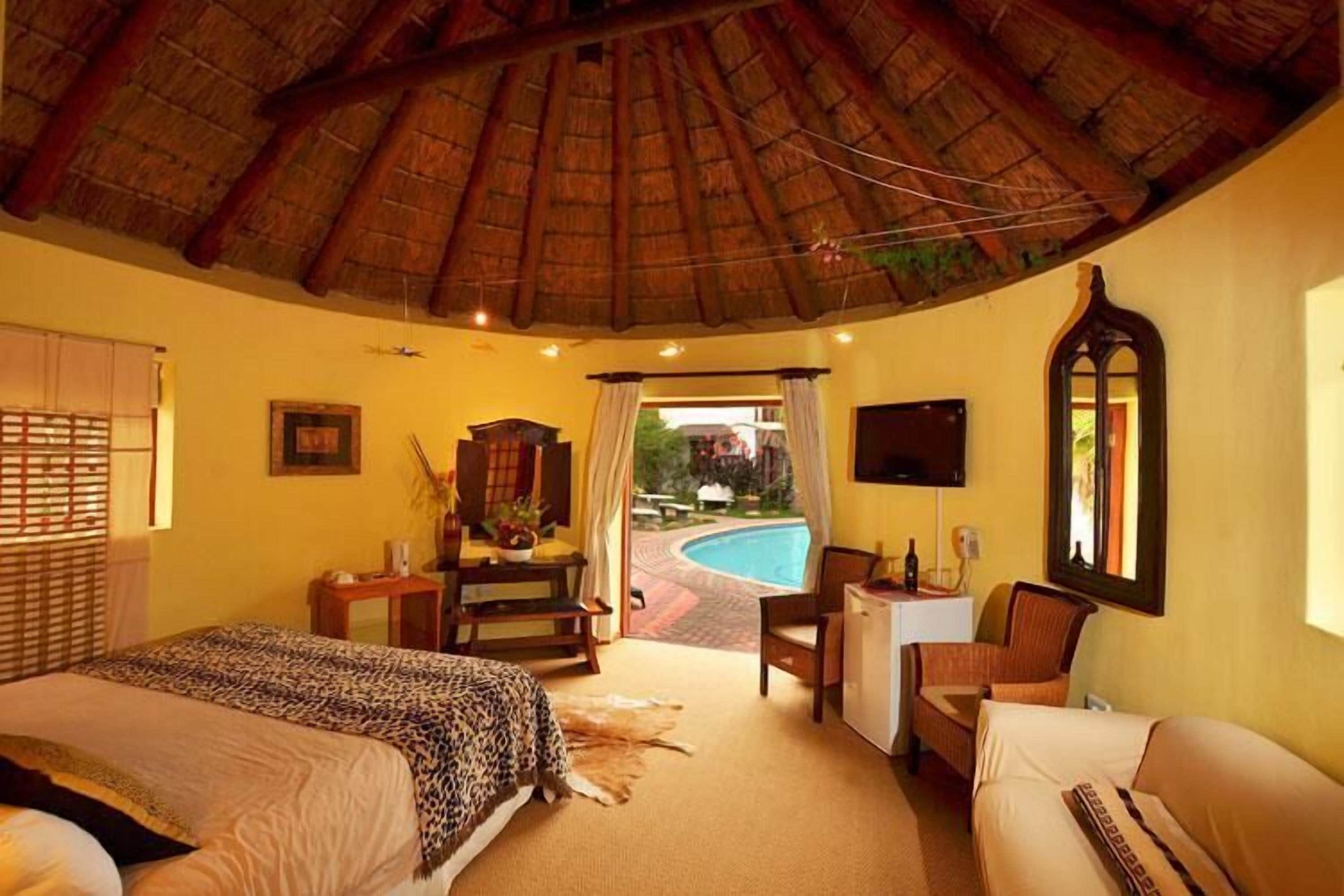 luxury poolside chalet | minibar, in-room safe, desk, iron/ironing board