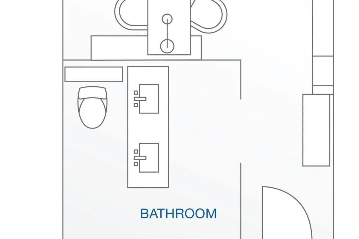 A floor plan of a hotel room with a bedroom, bathroom, and kitchenette.