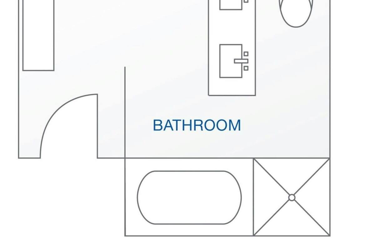 A bedroom with a bed, bedside tables, and a window. The bathroom includes a toilet, sink, and shower area.