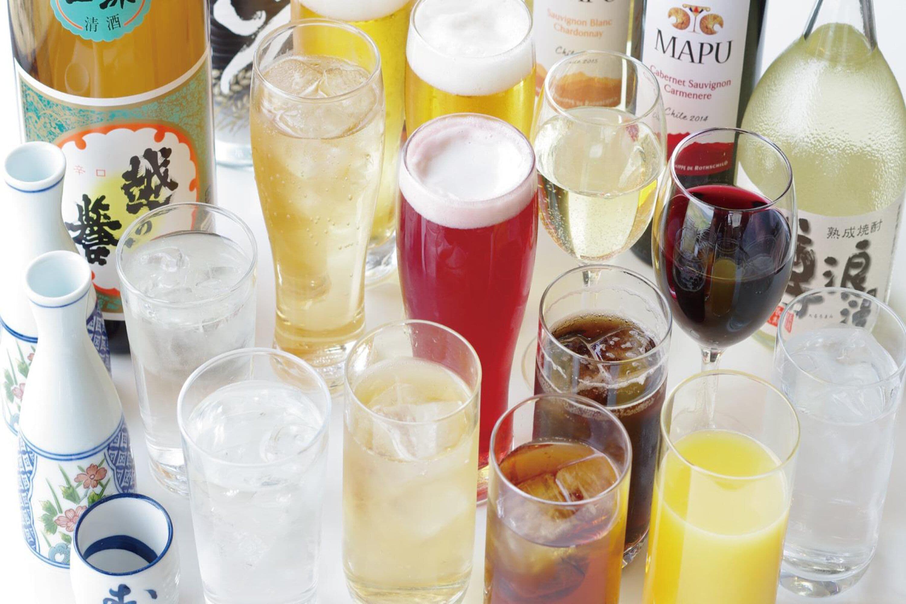 A variety of beverages including wine, beer, and cocktails in glasses and bottles.