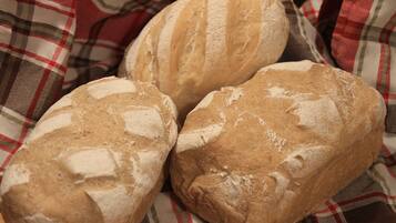 Three loaves of bread on a checkered cloth.