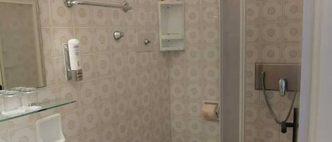A bathroom with a sink, toilet, and shower.