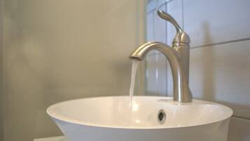 A bathroom sink with a modern faucet and a single drain.