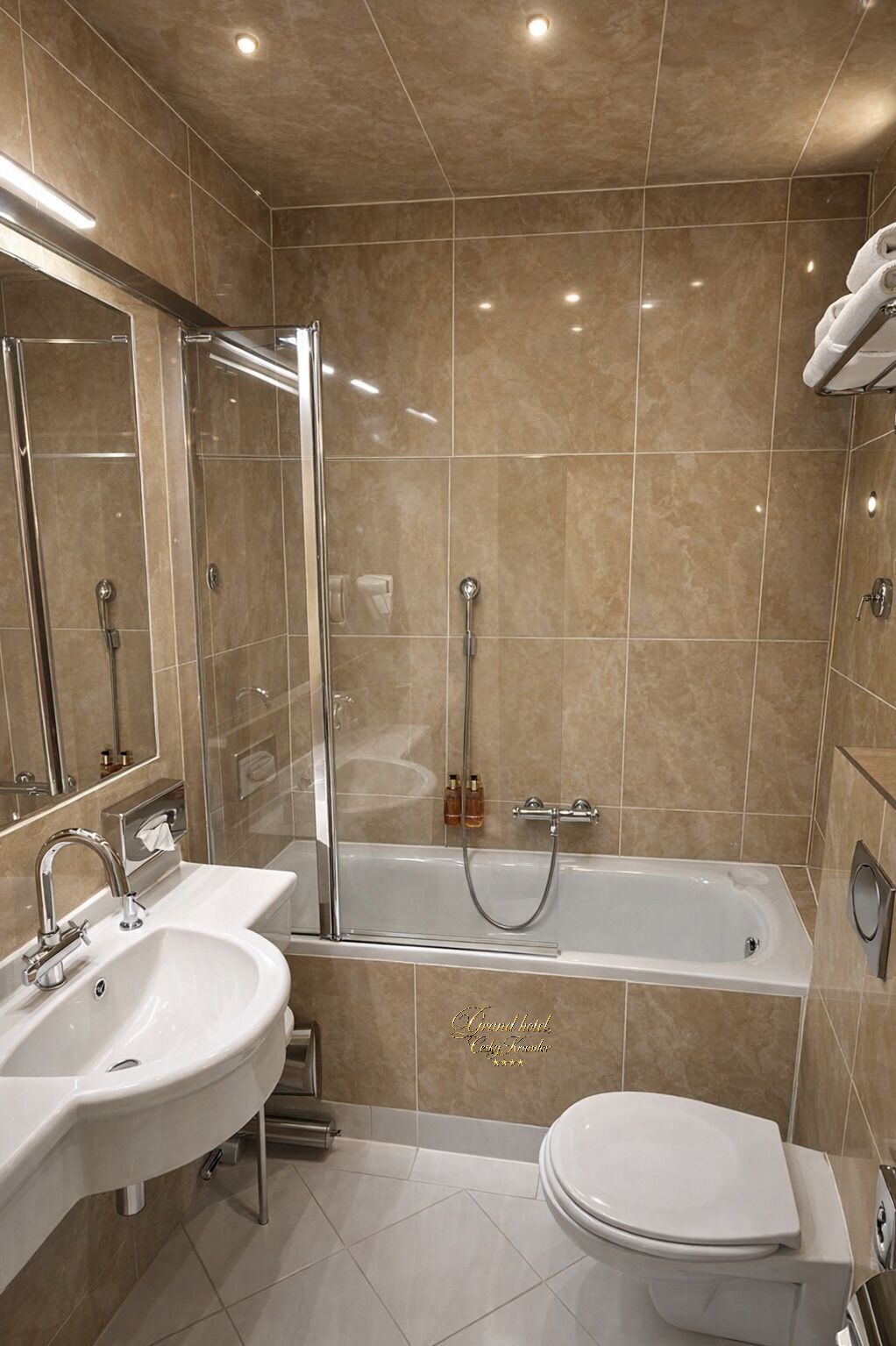 A modern bathroom with a bathtub, two sinks, a toilet, and a glass-enclosed shower.