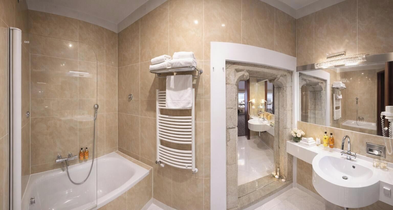 A modern bathroom with a bathtub, a glass-enclosed shower, a vanity with a sink, and a large mirror.