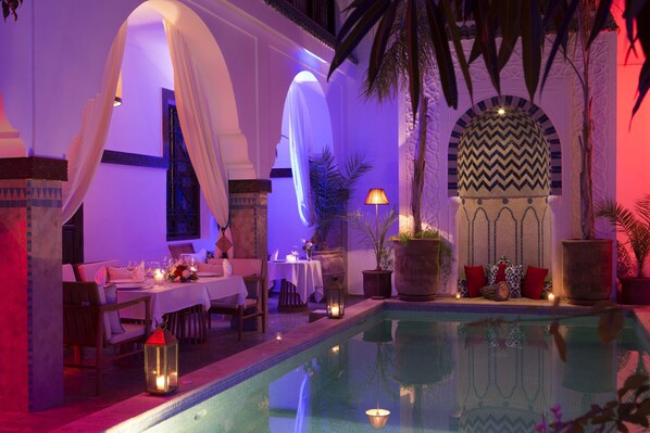 Alberca al aire libre y camastros 