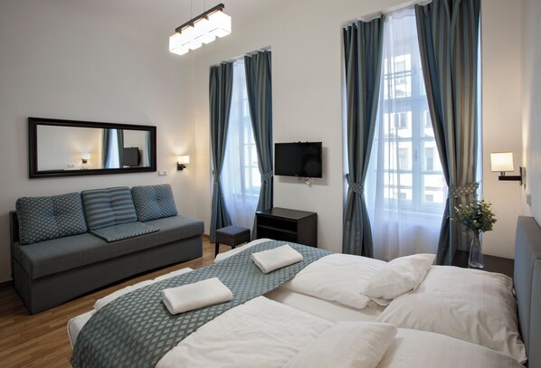 Classic Quadruple Room, City View | Premium bedding, pillow-top beds, in-room safe, blackout curtains
