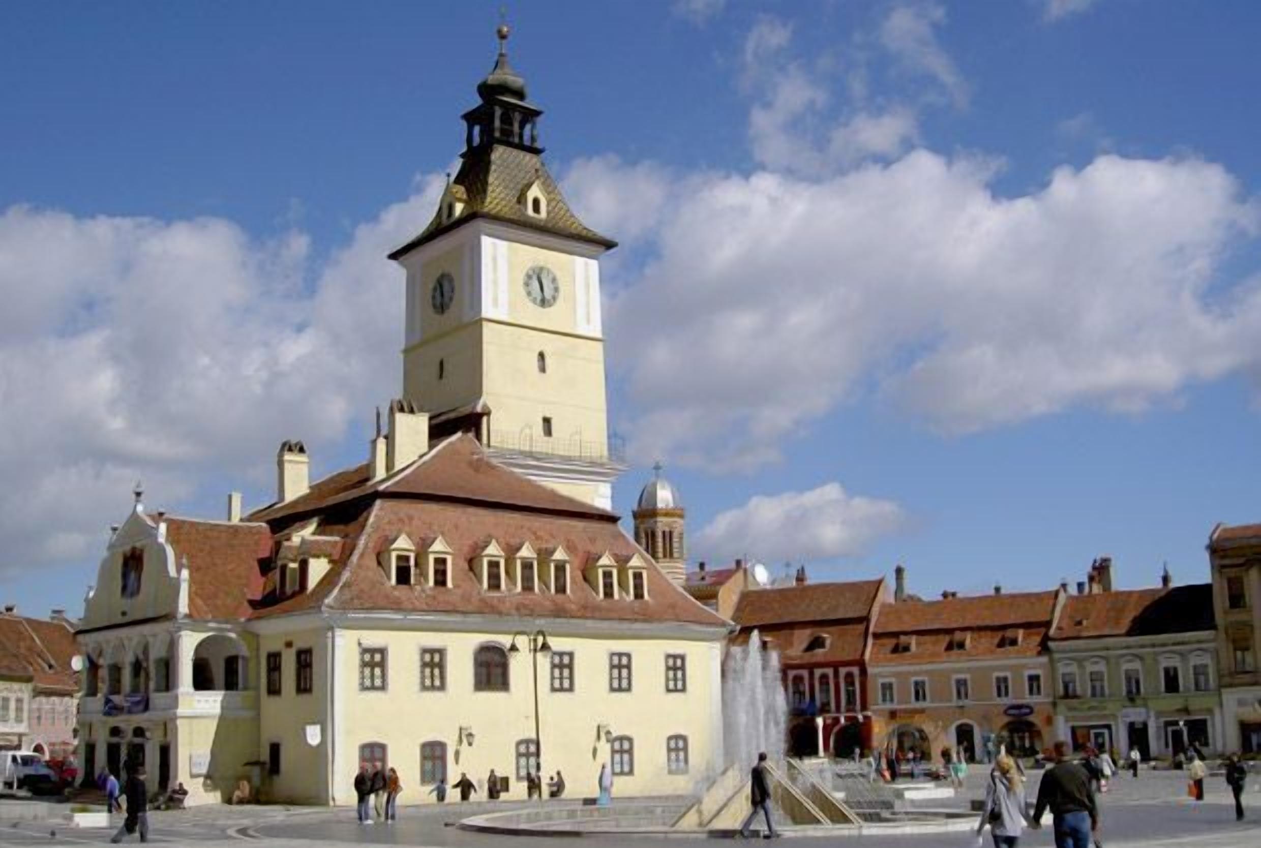 A historic building with a clock tower, a central courtyard, and surrounding traditional architecture.