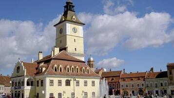 A historic building with a clock tower, a central courtyard, and surrounding traditional architecture.